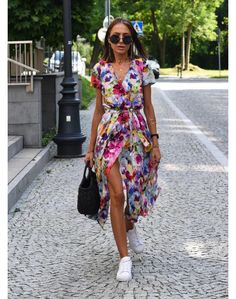 Imagine this: you're feeling the sun on your shoulders and a cool breeze dancing around you. You look down and see a splash of color and pattern that makes you smile – that's the Stella dress! This dress is where elegance meets effortless style. The flattering V-neckline and playful mix of florals and polka dots turn heads wherever you go. It's designed with a relaxed fit that's comfortable enough for a beach stroll yet chic enough for a night out. Made from a high-quality blend of polyester and cotton, this dress is breathable and perfect for spring, summer, and even those warm autumn days. Plus, it comes in a variety of colors and sizes, so you can find the perfect Stella to match your unique style. Stella Dress, Holiday Style, Fashion Elegant, Holiday Fashion, V Neck Dress, Style Dress, Elegant Fashion, Women's Fashion Dresses, Effortless Style