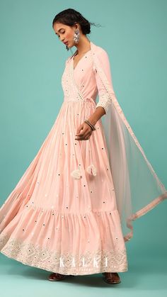 Walk down with elegance and class in our royal pearl pink anarkali kurta in lucknowi style geometric embroidery. The kurta is fabricated in cotton with a net dupatta. The kurta comes in an angarakha pattern cut with peplum style and a frill at the bottom. White Maxi