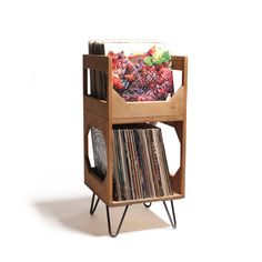 a record player stand with vinyl records on it's sides and a magazine rack in the middle