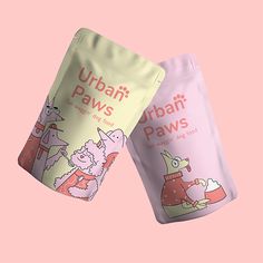 two bags of ubap paws on a pink background