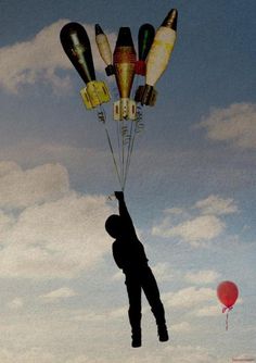 a man flying a bunch of balloons in the sky