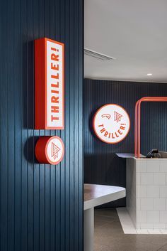 there is a sign that says thrifter on the wall next to a counter