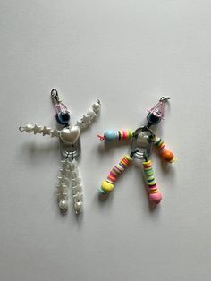 two small toy figures made out of beads