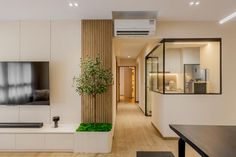 a living room filled with furniture and a flat screen tv on top of a wall