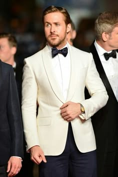 Ryan Gosling in a Ralph Lauren Purple Label ivory dinner jacket and navy tuxedo pants at the The Nice Guys premiere on May 15. White Tuxedo Jacket, White Wedding Suit, Navy Tuxedos, White Tux, Wedding Suits Groom