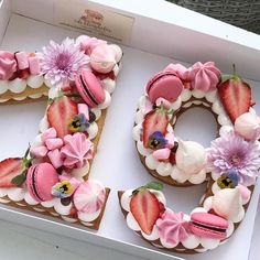 a cake in the shape of the number 50 decorated with strawberries and flowers