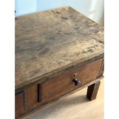 an old wooden table with two drawers