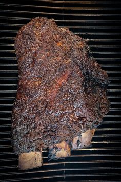 a large piece of meat cooking on top of a grill