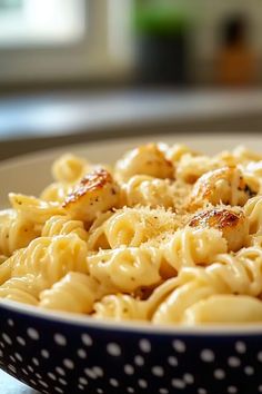 a bowl filled with macaroni and cheese on top of a table