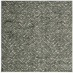 an area rug with grey and white patterns