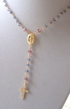 "This is a 14kt gold filled rosary inspired necklace made with this beautiful color combination is just tunning! London blue crystals with purple amethyst crystals measures 4mm, model is wearing a 16\" length. The length is the measurement around the neck only. Gold filled miraculous medal and cross measure 17x11mm with a 3\" drop. Spring clasp in back. Available in gold filled or 925 sterling silver. Ready to ship in 5-7 business days. I do offer expedited shipping options at checkout for rush Rosary Inspired Necklace, Catholic Cross Necklace, Gold Rosary Necklace, Cross Necklace Gold, Rosary Style Necklace, Silver Rosary, Catholic Necklace, Gold Rosary, Christian Necklace