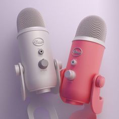 two pink and white microphones are next to each other