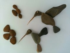 three birds made out of rocks sitting on top of each other