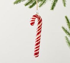 a candy cane ornament hanging from a christmas tree