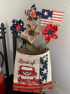 a patriotic flower pot with flowers in it