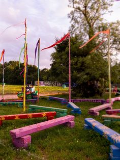 colorful park benches and flags in the grass