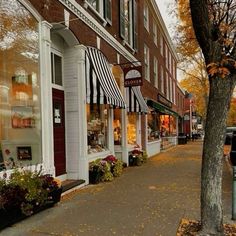 the storefronts are decorated with black and white striped awnings