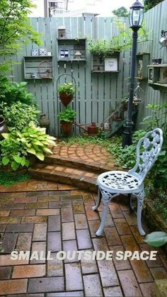 an outdoor patio area with a bench and potted plants