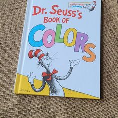 the dr seuss's book of colors is laying on top of a couch