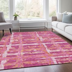 a living room with white couches and pink rug