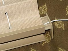 an electronic device is plugged in to the wall next to a carpeted floor