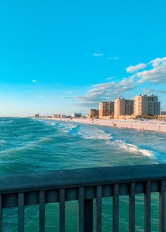 the beach is lined with buildings and people