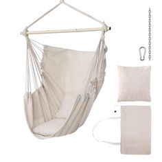 a white hammock hanging from a chain with two pillows and a pillow on it