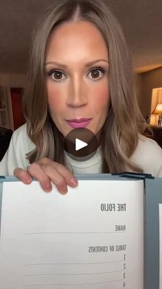 a woman holding up a book with the title'the follo name table of contents '