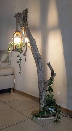 a tree that is sitting in the middle of a room with a light on it