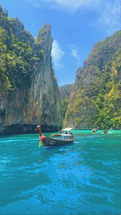 two boats are in the water near some cliffs and blue water with people on them