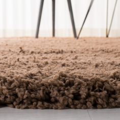 the carpet is brown in color and it looks like wool or something that has been cut off