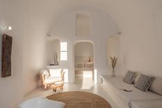 a living room filled with furniture and white walls