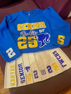 Graduate in style with this custom Senior Skirt Set! Sweatshirts can be done in your requested color, if available, and skirts are available in black or white. If you are requesting a different color skirt, please contact us before ordering. We can do sweatshirts or shirts.Complete Custom You can choose a design not pictured and work with our design team to bring it to life! Please ensure you send us the following information when ordering:1. School Name2. School Colors3. Skirt and Sweatshirt Co Senior Barbie, Senior Sweaters, Senior Skirt Set, Senior Skirt, Skirt And Sweatshirt, Senior Painted Jeans, Barbie Skirt, Senior Outfits, Birthday Outfit For Teens