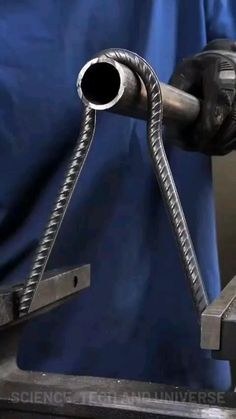 a close up of a metal object with a blue curtain in the backgroud