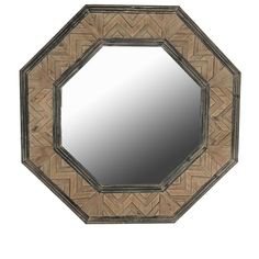 a mirror that is sitting on top of a wooden table with an intricate design in the middle