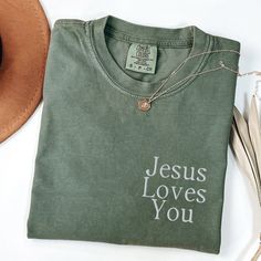 CHRISTMAS DEADLINE: We can no longer guarantee shipment by Christmas. Sorry :(  These soft and thick Comfort Colors shirts are embroidered with "Jesus Loves You" * 100% ring-spun cotton * Fabric weight: 6.1 oz/yd² (206.8 g/m²) * Garment-dyed * Relaxed fit * 7/8″ double-needle topstitched collar * Twill-taped neck and shoulders for extra durability * Double-needle armhole, sleeve, and bottom hems SIZING:  They're unisex but fit true to size (or very close to) for ladies. We recommend sizing up th Christian Tshirts Design, Jesus Merch Aesthetic, Basic Christan Shirts, Christian Fits, T Shirt Jesus Christ, Jesus Loves You Shirt, Worship Outfits, Jesus Shirts Christian Clothing Elevated Faith, Jesus Loves You Tee Shirt