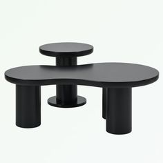 two black tables sitting next to each other on top of a white surface with no one in it