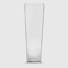 a tall glass vase sitting on top of a table