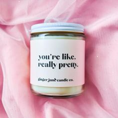 a candle that is on top of a pink cloth with the words you're like, really pretty