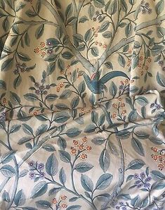 a blue and white floral print fabric with small flowers on the bottom half of it