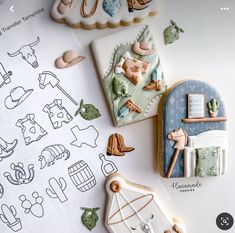 some cookies are laying on top of a table next to other cookie decorating items