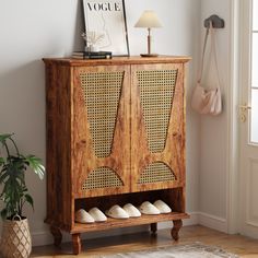 a wooden cabinet with some shoes on it