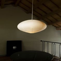 a round table and lamp hanging from the ceiling