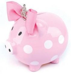 a pink pig with a bow on it's head is sitting in front of a white background