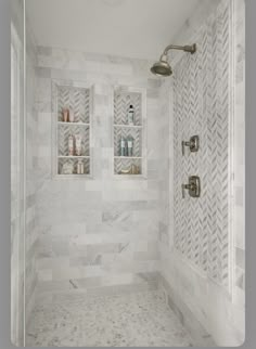 a walk in shower sitting next to a white tiled wall with shelves on the side