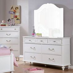 a white dresser and bed in a room