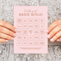 two hands holding up a pink wedding game