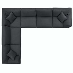 a couch that has pillows on it and is in the shape of a rectangle