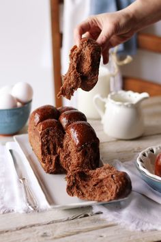 a person is scooping something out of a bundt cake