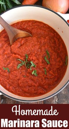 homemade marinara sauce in a white bowl with a wooden spoon next to it and vegetables on the side